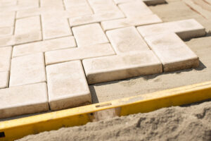 A close-up view of brick pavers arranged neatly on the ground, showcasing their texture and color variations.