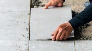 Low section man cementing paving stone