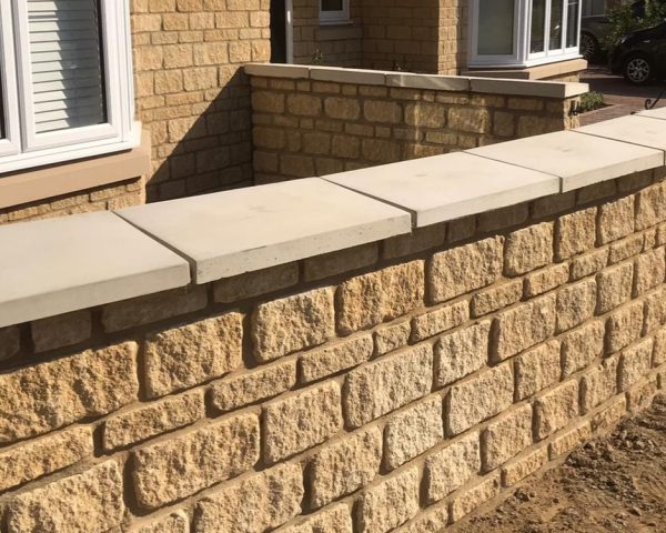 Once weathered coping in light grey laid on Cotswold walling